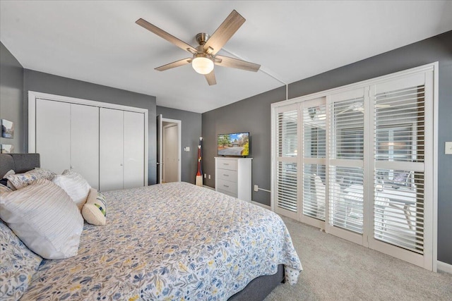 carpeted bedroom featuring a closet, multiple windows, and a ceiling fan