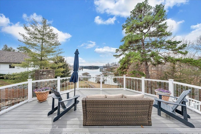 wooden deck featuring a water view and outdoor lounge area