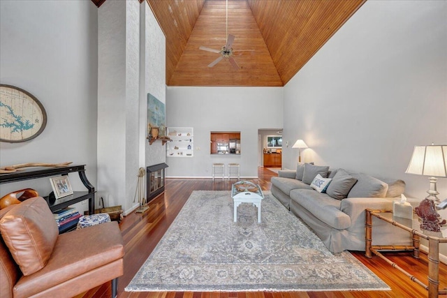 living room featuring wood finished floors, high vaulted ceiling, a fireplace, ceiling fan, and wood ceiling