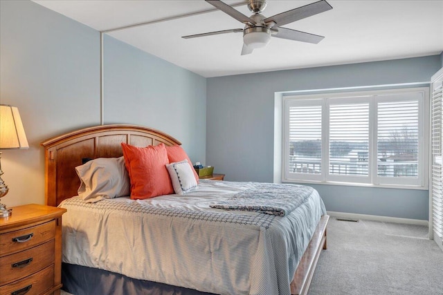 carpeted bedroom featuring a ceiling fan, baseboards, and visible vents