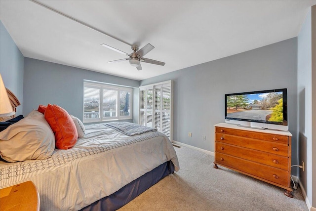 carpeted bedroom featuring baseboards and ceiling fan