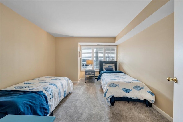 bedroom with baseboards and carpet