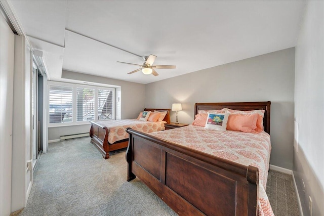 bedroom featuring a baseboard radiator, baseboards, light colored carpet, and ceiling fan