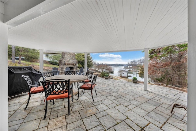 view of patio with outdoor dining space and an outdoor stone fireplace