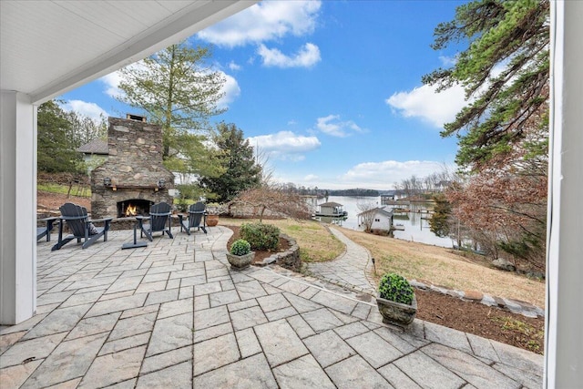 view of patio / terrace featuring an outdoor stone fireplace