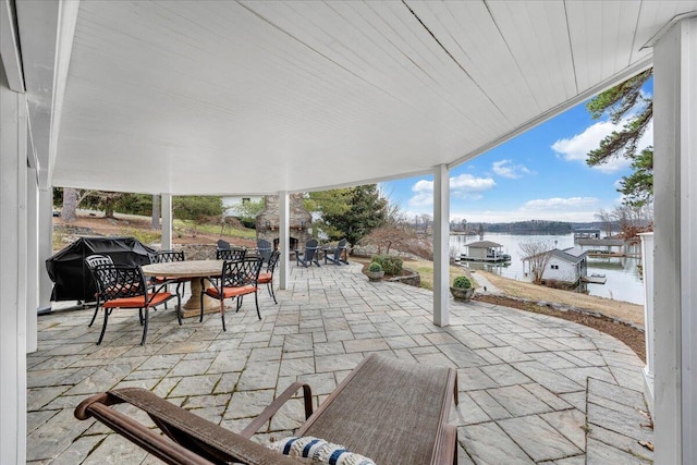 view of patio / terrace with outdoor dining area and a water view