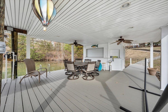 deck featuring outdoor dining area and a ceiling fan