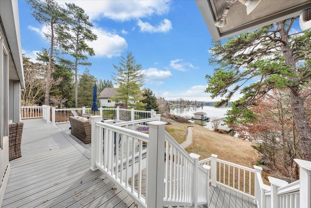 wooden terrace featuring a water view