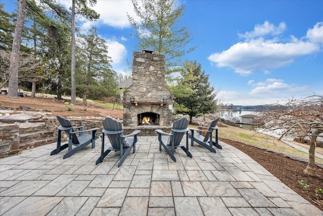 view of patio with an outdoor stone fireplace