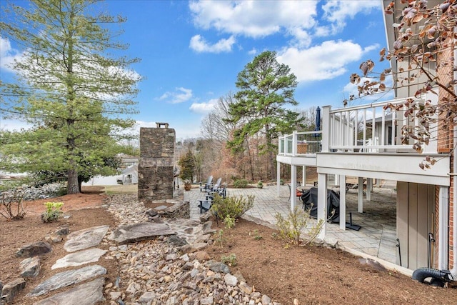 view of yard featuring a deck and a patio