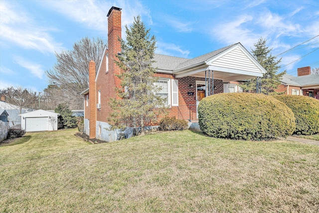 bungalow featuring an outbuilding, a garage, and a front yard