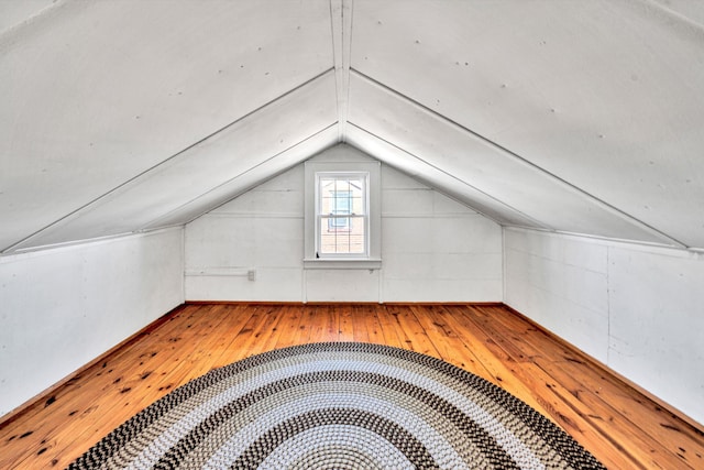 additional living space featuring hardwood / wood-style flooring and lofted ceiling