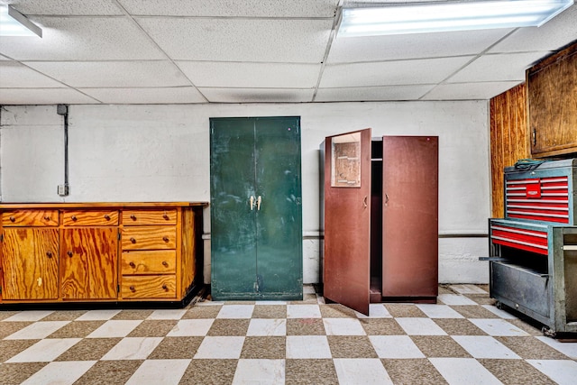 basement featuring a paneled ceiling