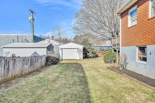 view of yard featuring an outbuilding and a garage