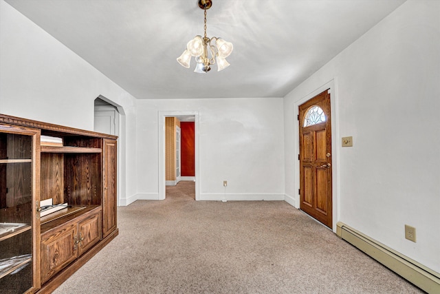 unfurnished living room featuring a baseboard radiator, light carpet, and a notable chandelier