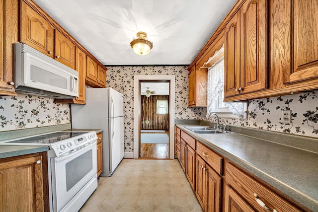 kitchen featuring sink and white appliances