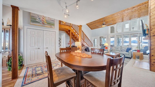 dining area with high vaulted ceiling, ceiling fan, and track lighting