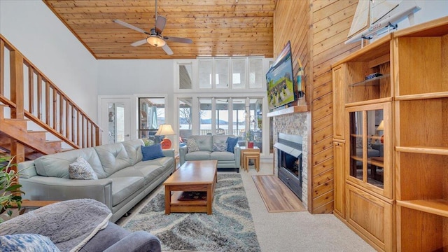 carpeted living room featuring ceiling fan, high vaulted ceiling, and wood ceiling