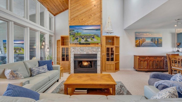 living room with carpet floors, high vaulted ceiling, wooden ceiling, and a stone fireplace