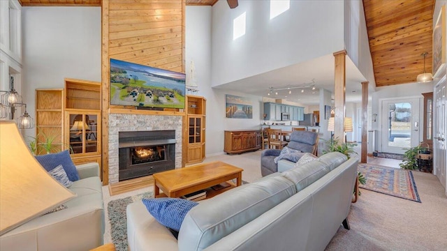 living room featuring a fireplace, light carpet, and a towering ceiling