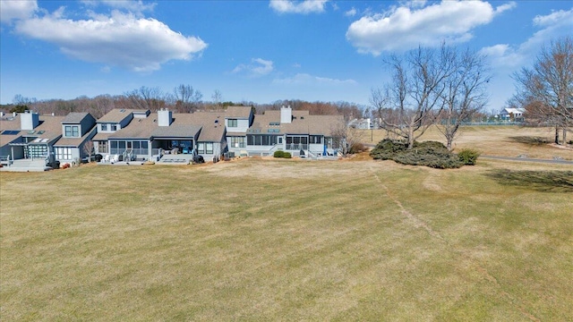 rear view of house featuring a lawn