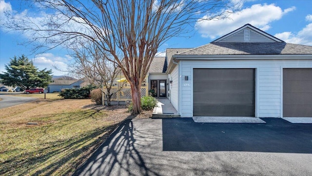 view of side of home with a yard and a garage