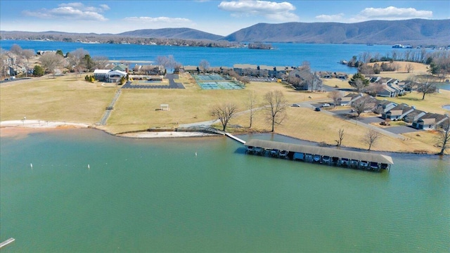 birds eye view of property with a water and mountain view