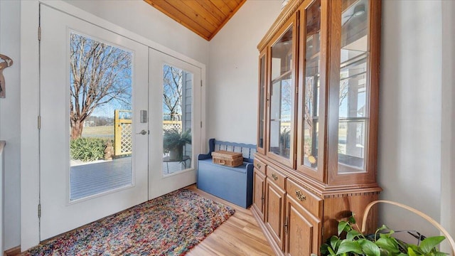 doorway featuring light wood-type flooring, french doors, and lofted ceiling