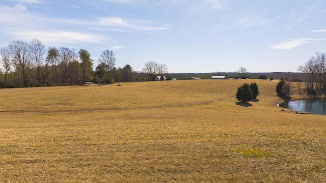 view of yard featuring a water view and a rural view