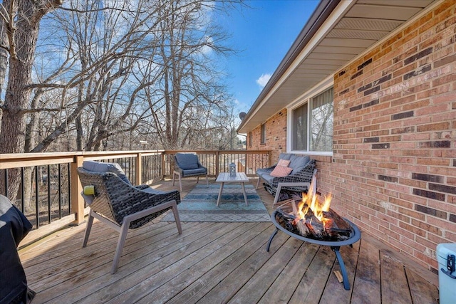 wooden deck featuring an outdoor fire pit