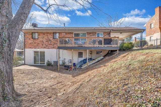 rear view of property with a wooden deck and central air condition unit