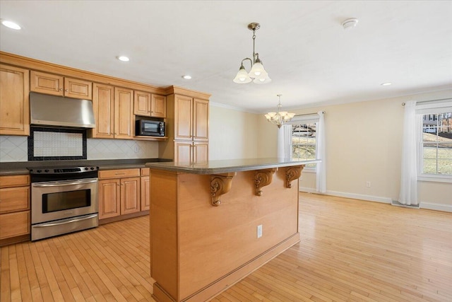 kitchen featuring dark countertops, under cabinet range hood, black microwave, and electric range