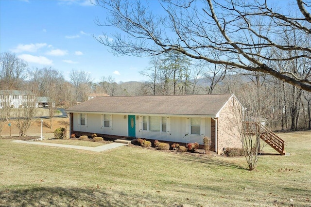 ranch-style house featuring a porch and a front yard