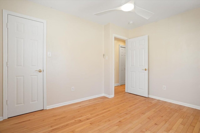 unfurnished bedroom with ceiling fan, light wood-style flooring, and baseboards