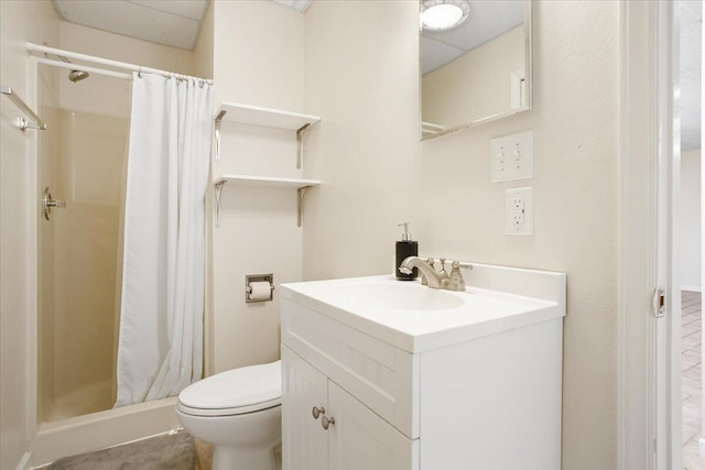 bathroom with vanity, toilet, and a shower stall