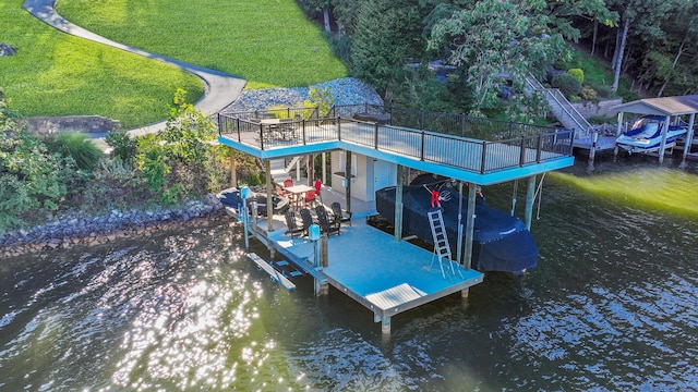 dock area with a lawn, a water view, and boat lift