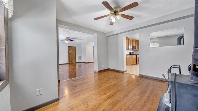 living room featuring ceiling fan and light wood-type flooring