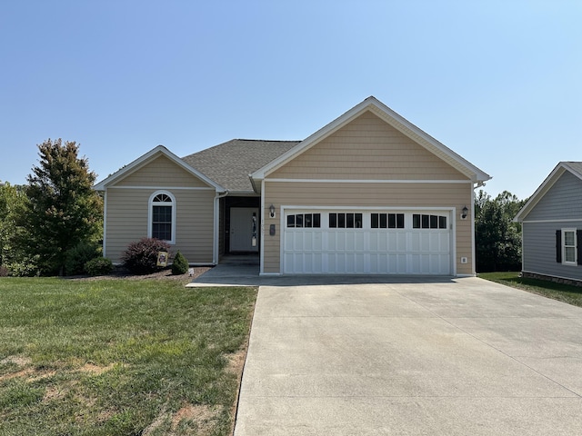 ranch-style house with a garage and a front lawn