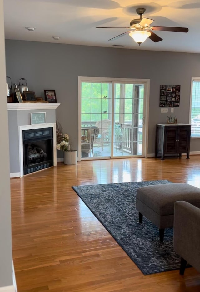 1057 Barrow Hills Dr, Huddleston, VA 24104 - living area featuring ceiling fan, wood finished floors, a fireplace, and baseboards