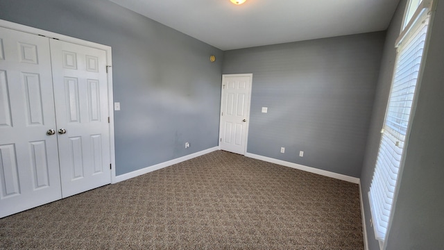 1057 Barrow Hills Dr, Huddleston, VA 24104 - unfurnished bedroom featuring dark colored carpet, baseboards, and a closet