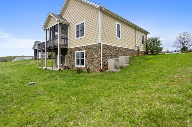 1057 Barrow Hills Dr, Huddleston, VA 24104 - view of property exterior featuring a yard, central air condition unit, a sunroom, and stone siding
