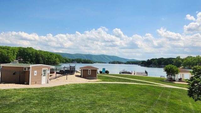 1057 Barrow Hills Dr, Huddleston, VA 24104 - view of grassy yard with a water and mountain view, a dock, an outdoor structure, and a storage unit