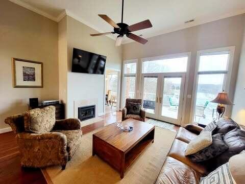 living room with french doors, ceiling fan, crown molding, and hardwood / wood-style floors