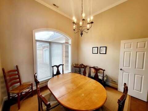 dining room featuring crown molding, lofted ceiling, and a chandelier