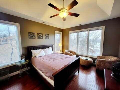 bedroom featuring lofted ceiling, dark hardwood / wood-style floors, and ceiling fan