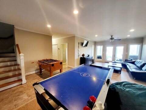 playroom featuring ornamental molding and ceiling fan