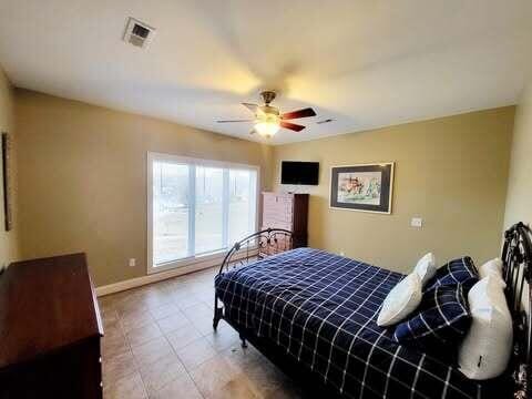 tiled bedroom with ceiling fan