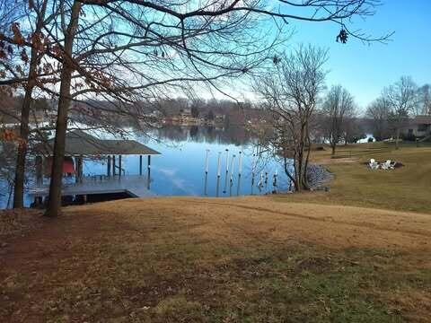 dock area with a yard and a water view