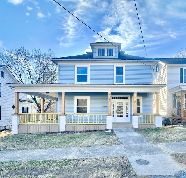 american foursquare style home featuring a porch