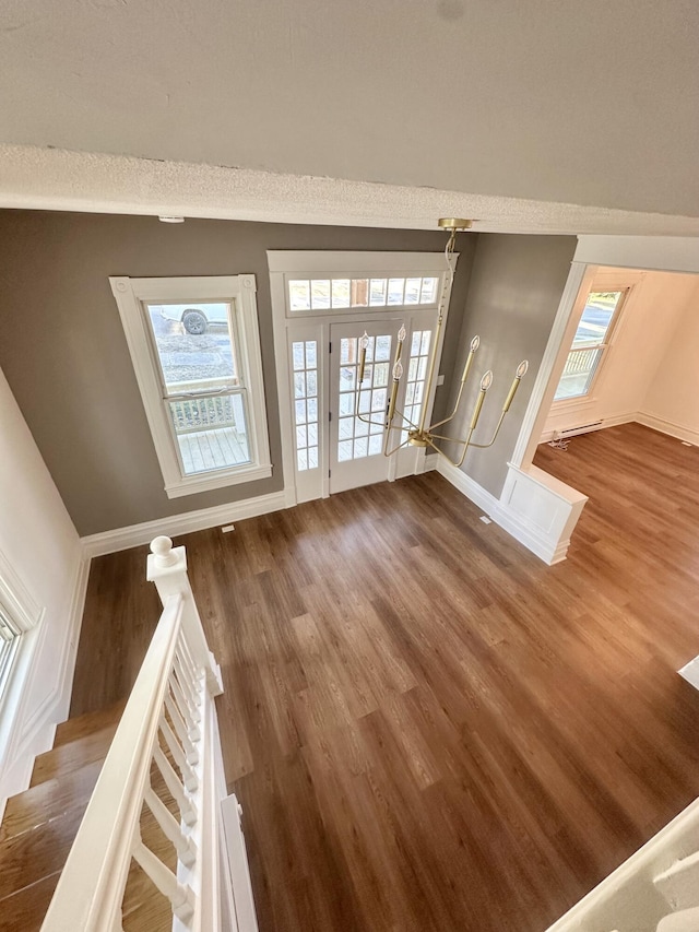 interior space with dark wood-style floors, stairway, and baseboards